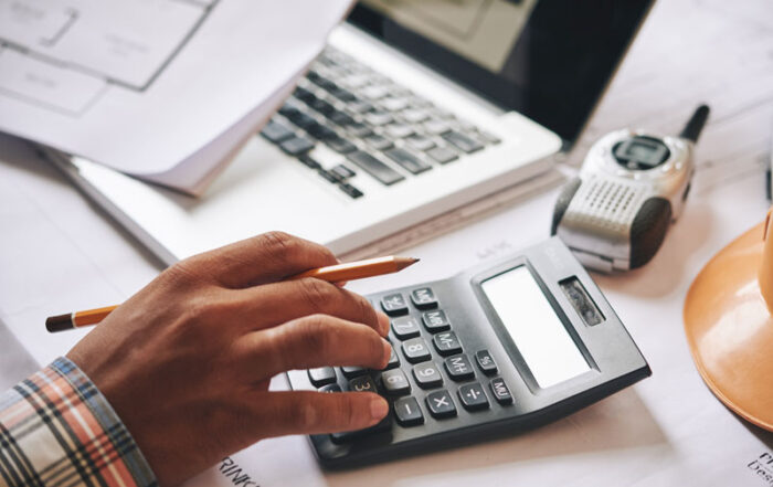 Person using calculator in project estimate